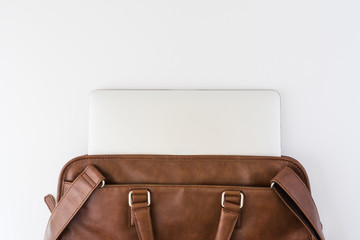 Brown business leather briefcase with notebook isolated background