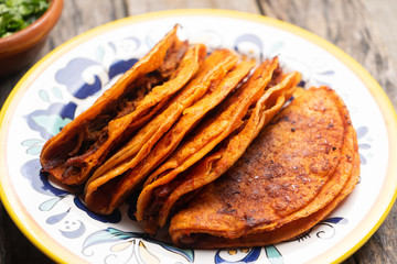Mexican beef barbacoa tacos on wooden background