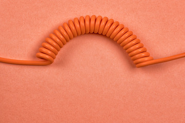 Orange spiral cable on orange background