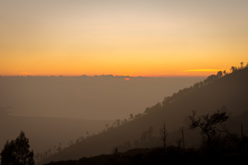 Stunning sunrise or sunset on Ijen Crater. Ijen Crater is a volcanic tourism attraction in Indonesia, located on East Java, famously contains the world’s largest acidic volcanic crater lake.