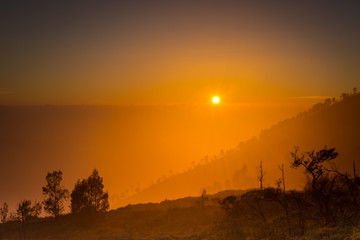 Stunning sunrise or sunset on Ijen Crater. Ijen Crater is a volcanic tourism attraction in Indonesia, located on East Java, famously contains the world’s largest acidic volcanic crater lake.