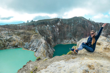 Kelimutu - A girl admiring turquoise coloured volcanic lakes