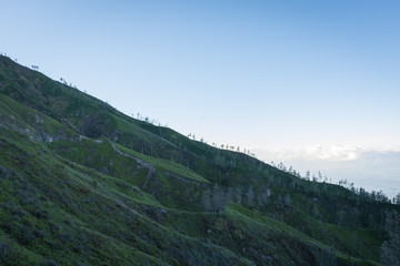 Fototapeta na wymiar Stunning view on Ijen Crater. Ijen Crater is a volcanic tourism attraction in Indonesia, located on East Java, famously contains the world’s largest acidic volcanic crater lake.