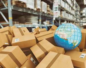 Earth globe on a pile of boxes in a shipping warehouse