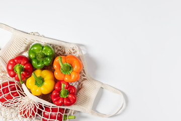 Zero waste concept. Vegetables in eco friendly string bag on white background.