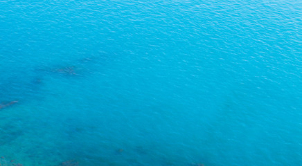  Azure sea. Shine through the stones under water.
