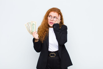 red head young woman feeling bored, frustrated and sleepy after a tiresome, dull and tedious task,...