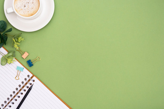Office table with notebook and coffee cup. Table top, work space with copy space. Creative flat lay.