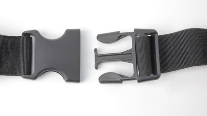 black plastic Fastex clip for backpacks on a white background. items of clothing and equipment