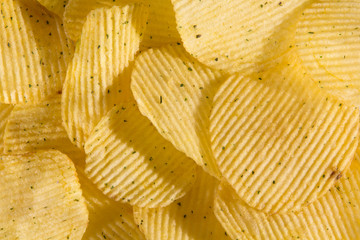 Rippled potato chips with condiment. Background. Top view .