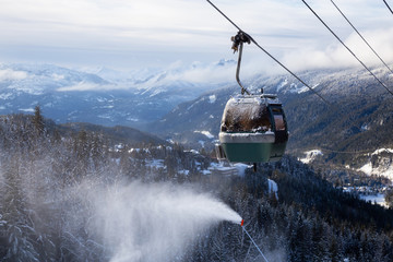 Whistler, British Columbia, Canada. Gondola going up the mountain during a vibrant and sunny winter day.