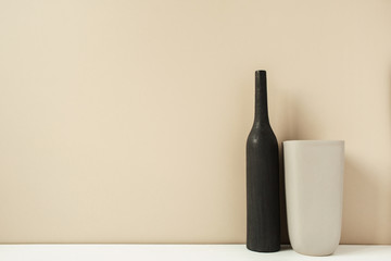 Two stylish vases, bottles on pastel neutral beige background. Modern minimalist interior decoration design concept.
