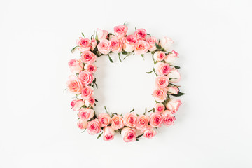 Flat lay square frame border with blank copy space mockup made of pink rose flower buds on white background. Top view floral concept.