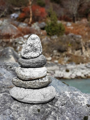 Everest base camp trek itinerary: way from Namche Bazar to Phortse Tanga, Solokhumbu, Nepal. Dudh Koshi river near Phortse Tanga village. Stone pyramide on its bank.