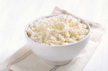 Curd cheese, cottage cheese in white bowl