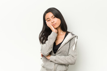 Fototapeta na wymiar Young fitness chinese woman who is bored, fatigued and need a relax day.