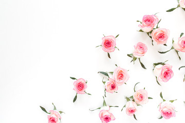 Floral composition with pink rose flower buds and leaves pattern on white background. Flatlay, top view.