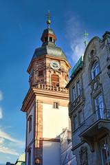 Fototapeta na wymiar Heidelberg, Germany - January 2020: Tower with clock of catholic church called 'Providenzkirche' in city center of Heidelberg in Germany, under construction