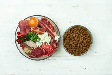 Natural raw dog food as opposite of kibble dry food concept photo. 