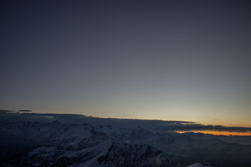 A view from the summit of a himalayan mountain before sunrise