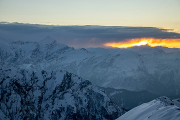 A beautiful view of a sunrise and himalayan mountains from the summit of a himalayan mountain