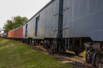 Fototapeta na wymiar Row of old rusted railroad train cars