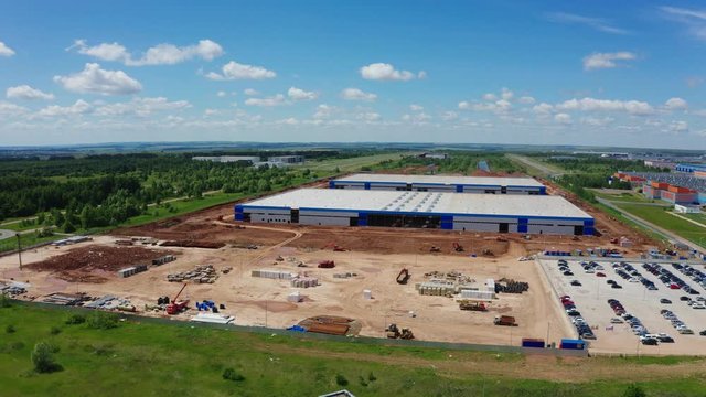 construction site of warehouse by industrial complex aerial