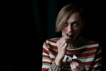Young guy eating candy