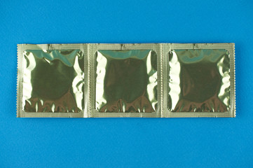 three condoms on a blue background