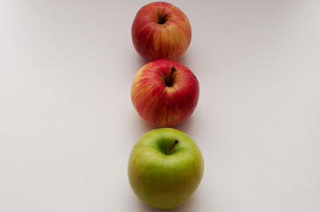 three isolated apples on a white background top view