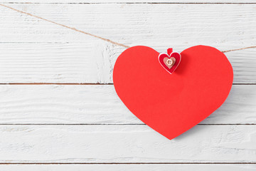 red paper heart on old wooden background