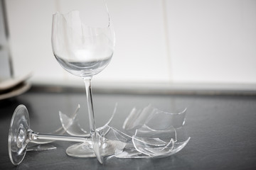 Broken Plate or broken water glass on the on the floor in the kitchen The concept of accidents in...
