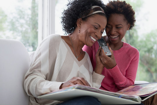 Mother And Adult Daughter Sharing A Telephone Conversation