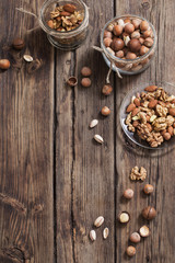 mix of nuts on  old wooden surface
