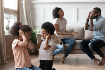 Little black kids suffering from parents emotional quarrel.