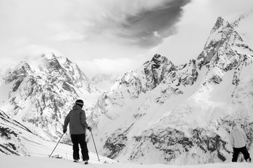 Fototapeta na wymiar Skier and snowboarder before downhill on off-piste ski slope