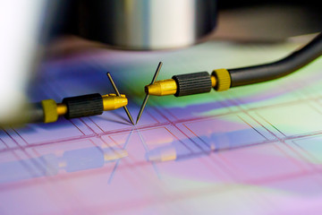 Manual probe system with needles for test of semiconductor on silicon wafer. Selective focus.