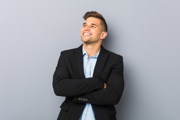 Young handsome caucasian man smiling confident with crossed arms.