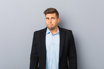 Young handsome caucasian man confused, feels doubtful and unsure.