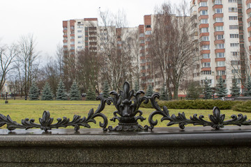 wrought iron cast-iron grate on the fence in the form of flowers, branches and curls. forged fence,...