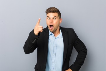 Young handsome caucasian man having an idea, inspiration concept.