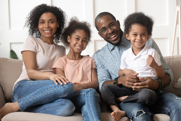 Happy cute black family of four portrait.