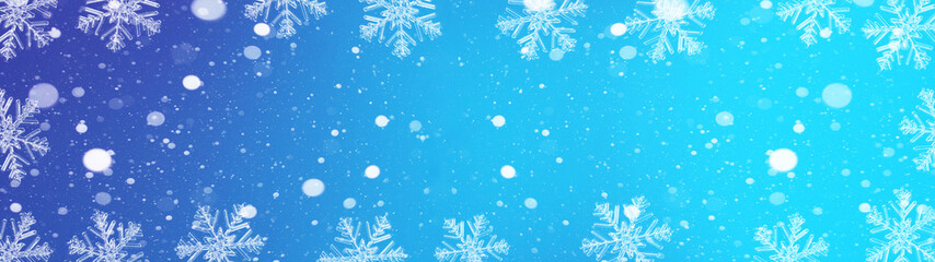 Fototapeta na wymiar snowflakes and ice crystals isolated on blue sky - winter background panorama banner long 