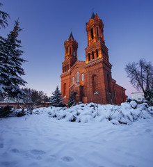 Fototapeta na wymiar Church of St. Barbara in Vitebsk. The building was shot during dusk, with the lights on.
