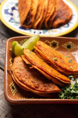 Mexican beef barbacoa tacos on wooden background