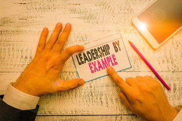 Writing note showing Leadership By Example. Business concept for Becoming role model for showing...