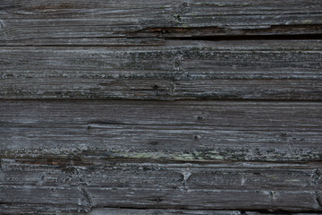 Fragment of an old wall made of horizontal wooden boards without paint. From time to time, the material became gray and textured. Background. Texture.