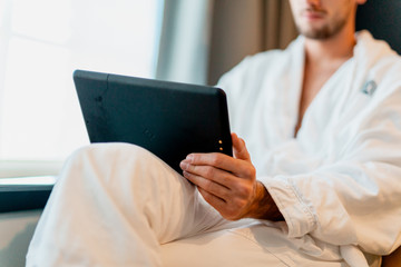 Man on tablet ordering in hotel morning