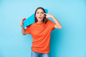 Young caucasian skater woman isolated showing a disappointment gesture with forefinger.