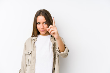 Young caucasian woman  isolated showing number one with finger.